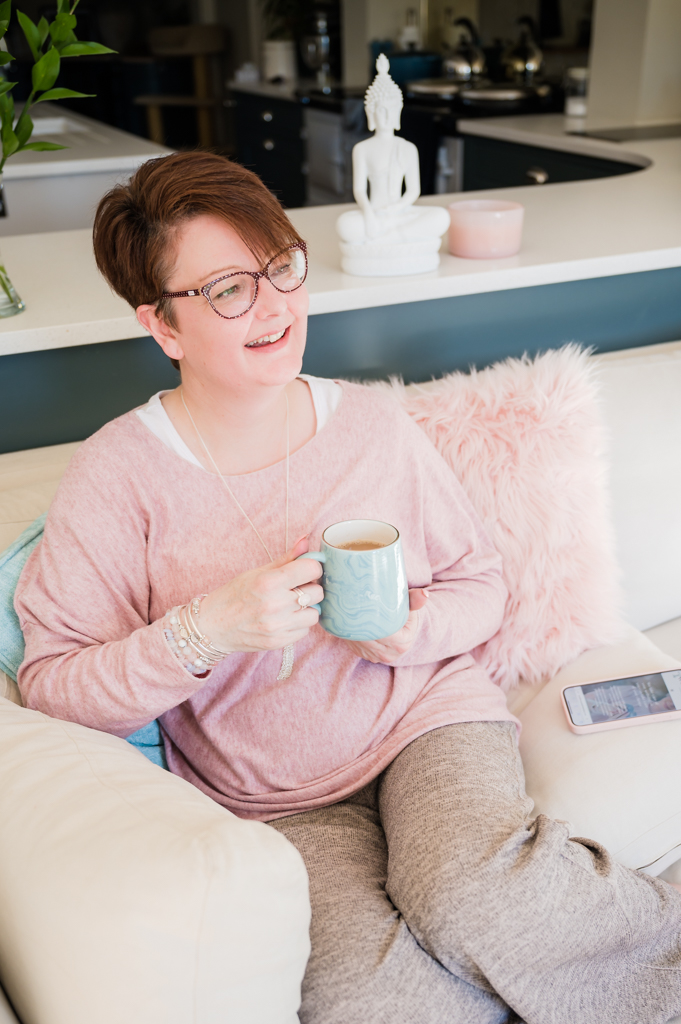 Female Business woman sitting on a sofa with cup of tea