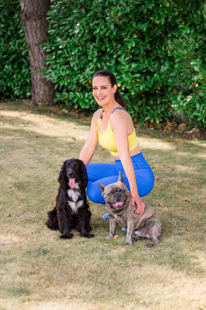 Celeb posing in activewear with her two dogs